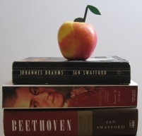 Music books with apple with eighth note stem and leaf